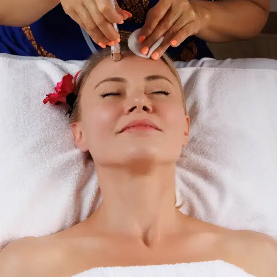 A client receiving a professional facial service at Blue Diamond Thai Spa